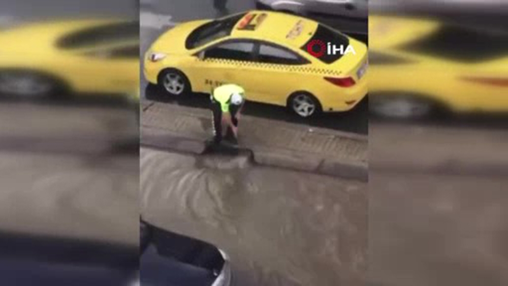 Trafik polisi caddeyi basan suyun tahliyesi için seferber oldu